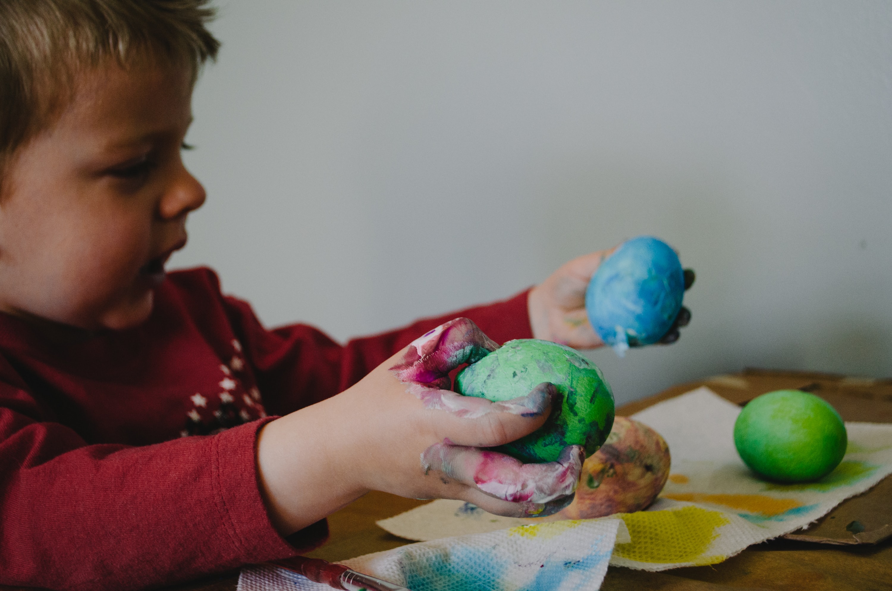 Toddler playing with different coloured play dough