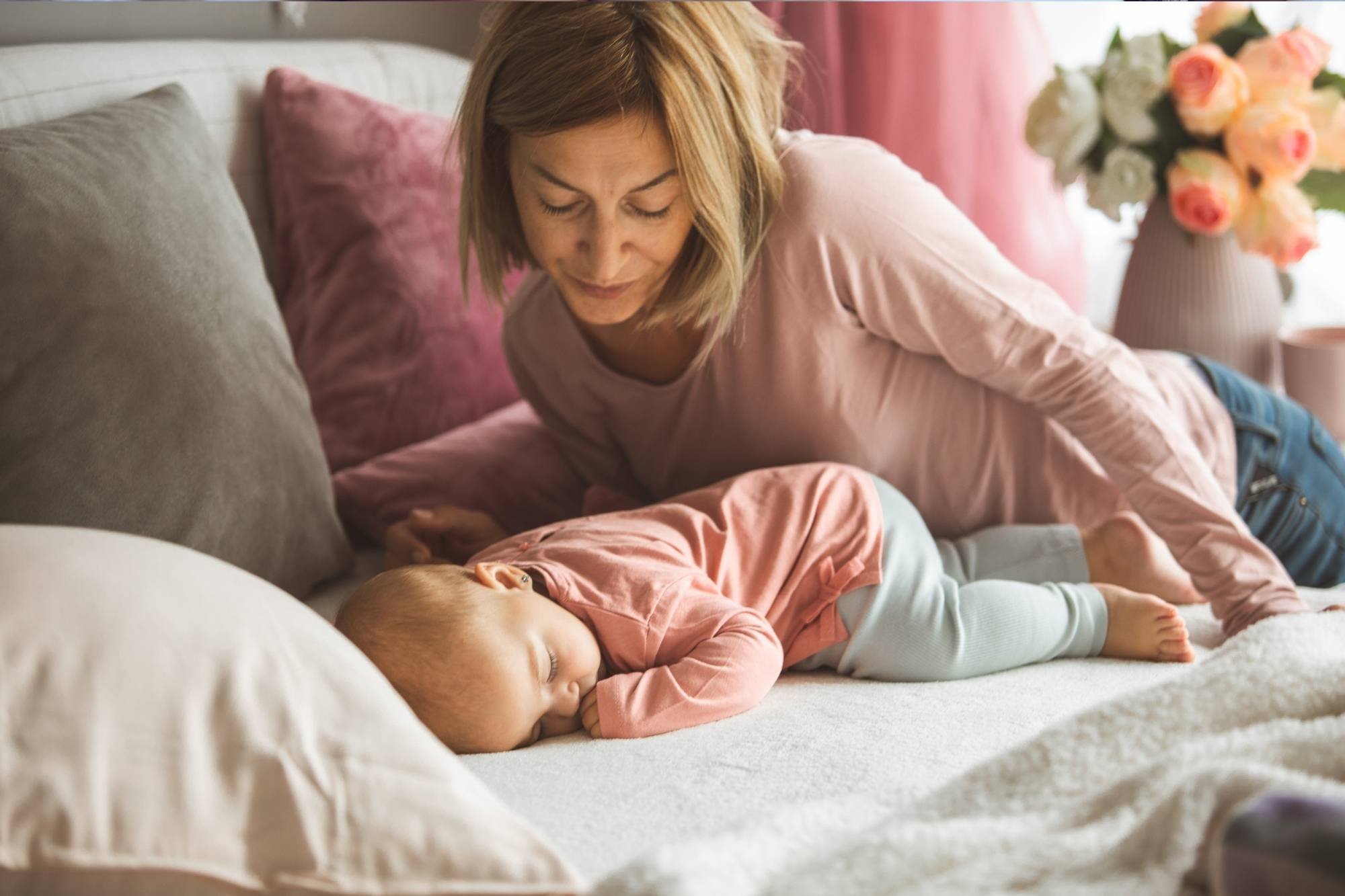 Mother looking at her sleeping baby 