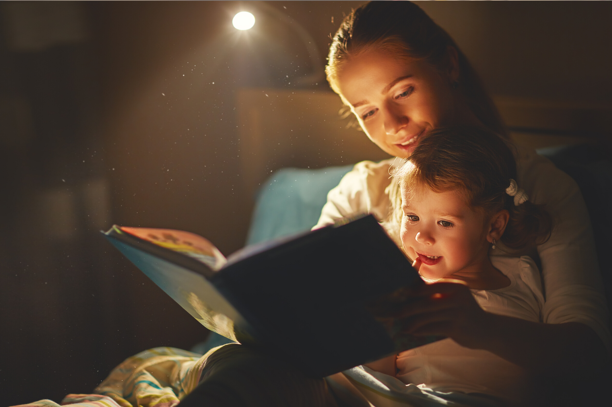 Mum reading a book with her baby on her lap