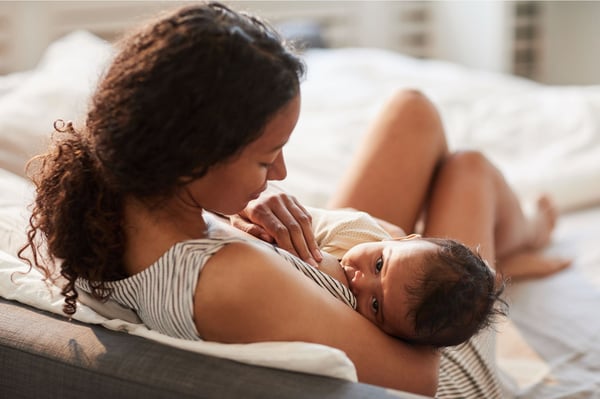 Mother sat down breastfeeding her baby