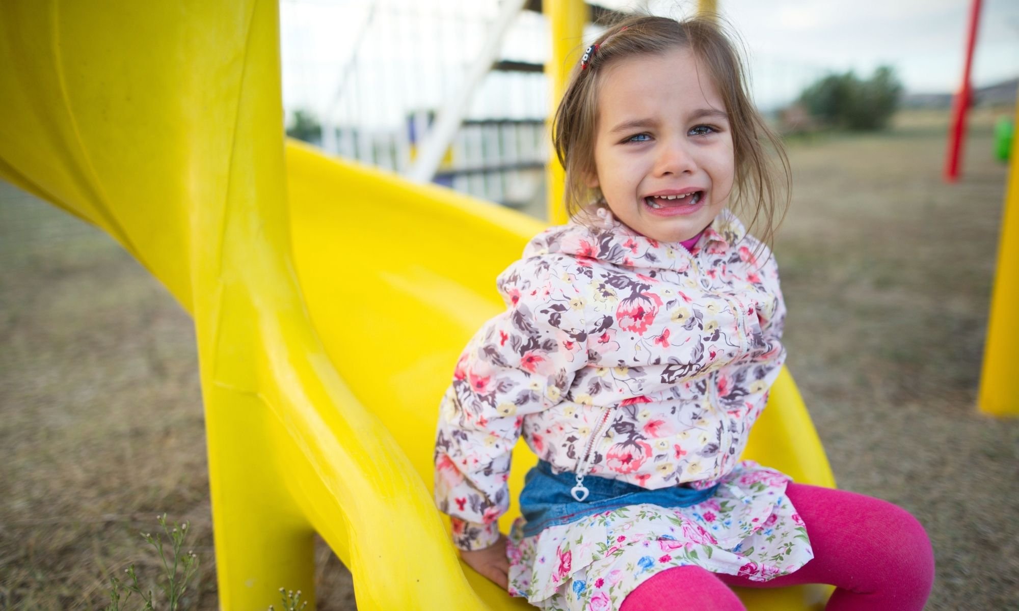 A child having a tantrum in the playground