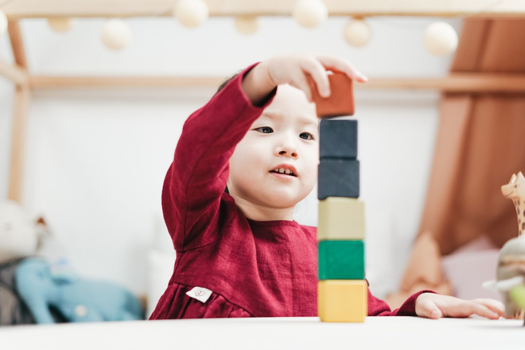 Child building a tower with colourful bricks 