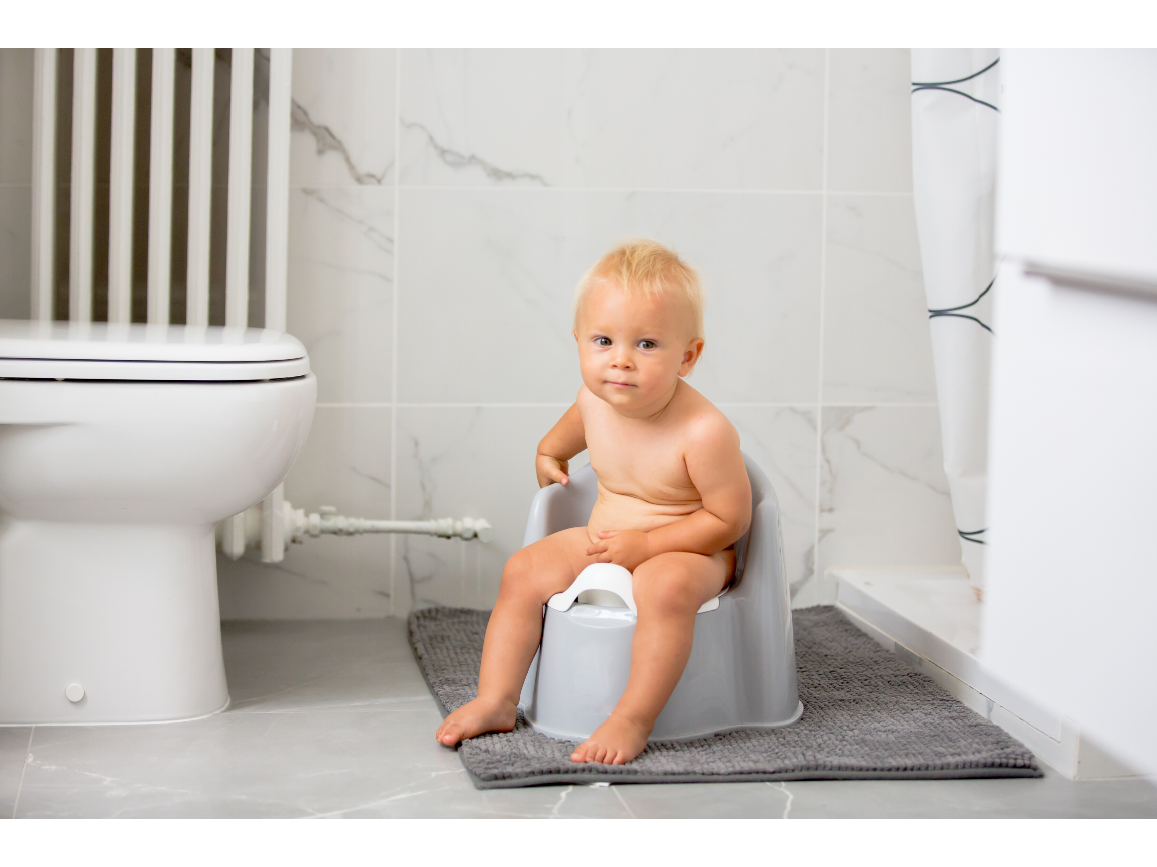 Child sitting on a potty in the bathroom