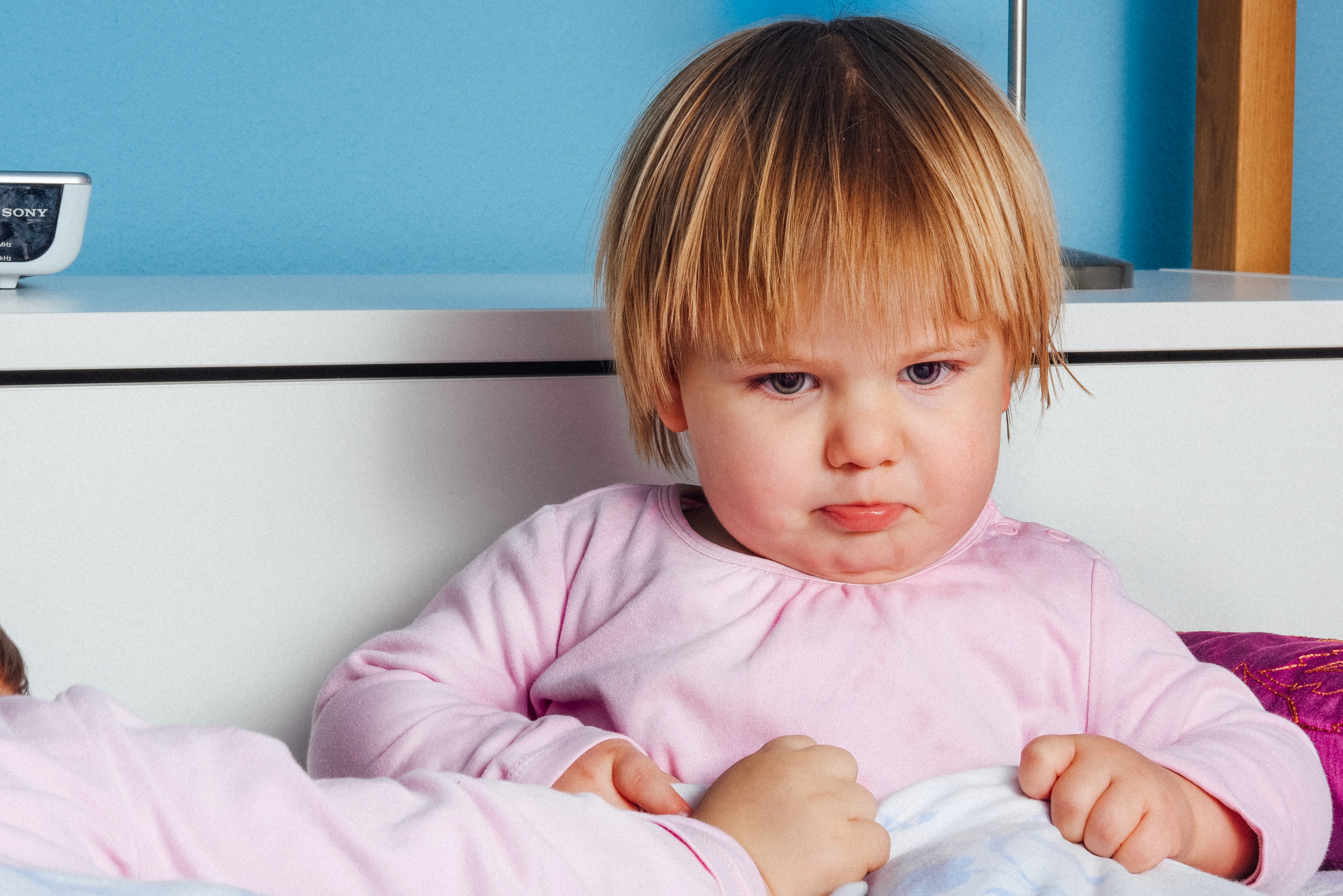 Upset child sitting in bed