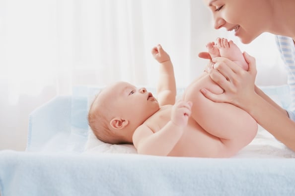 Mother cuddling her naked baby