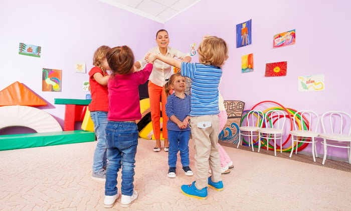 Toddlers back at their nursery playing with their friends and teacher