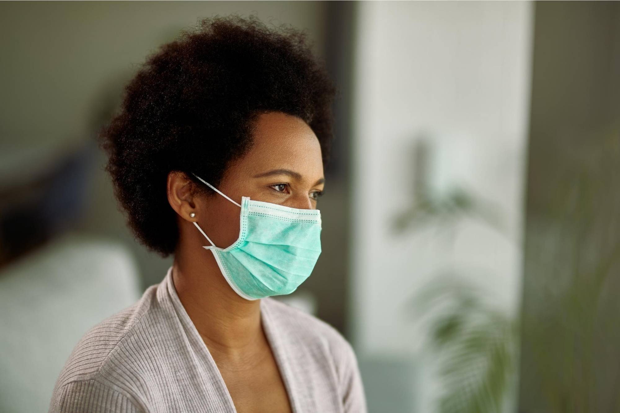 Short haired woman wearing blue face mask