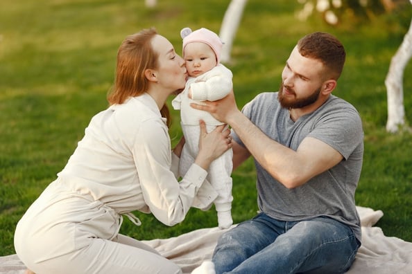 mother holding baby with dad nearby 2