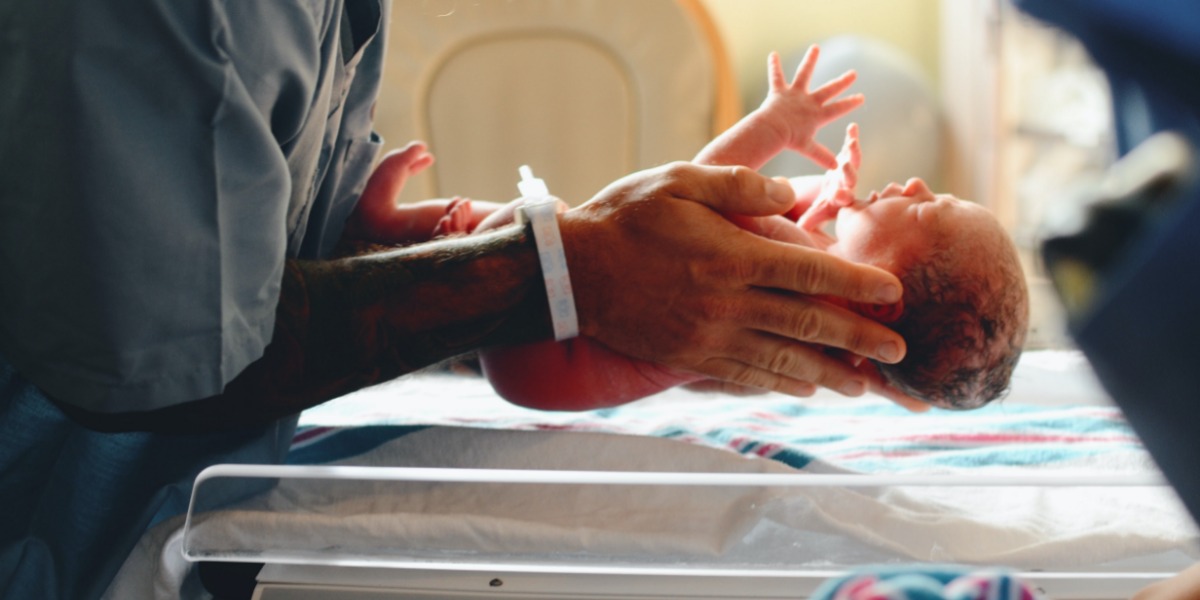 Parent holding their baby that was born during the Covid-19 pandemic