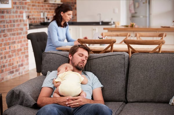 Lockdown family with baby in sleeping dad's arms 