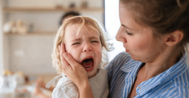 Mum trying to soothe her crying baby