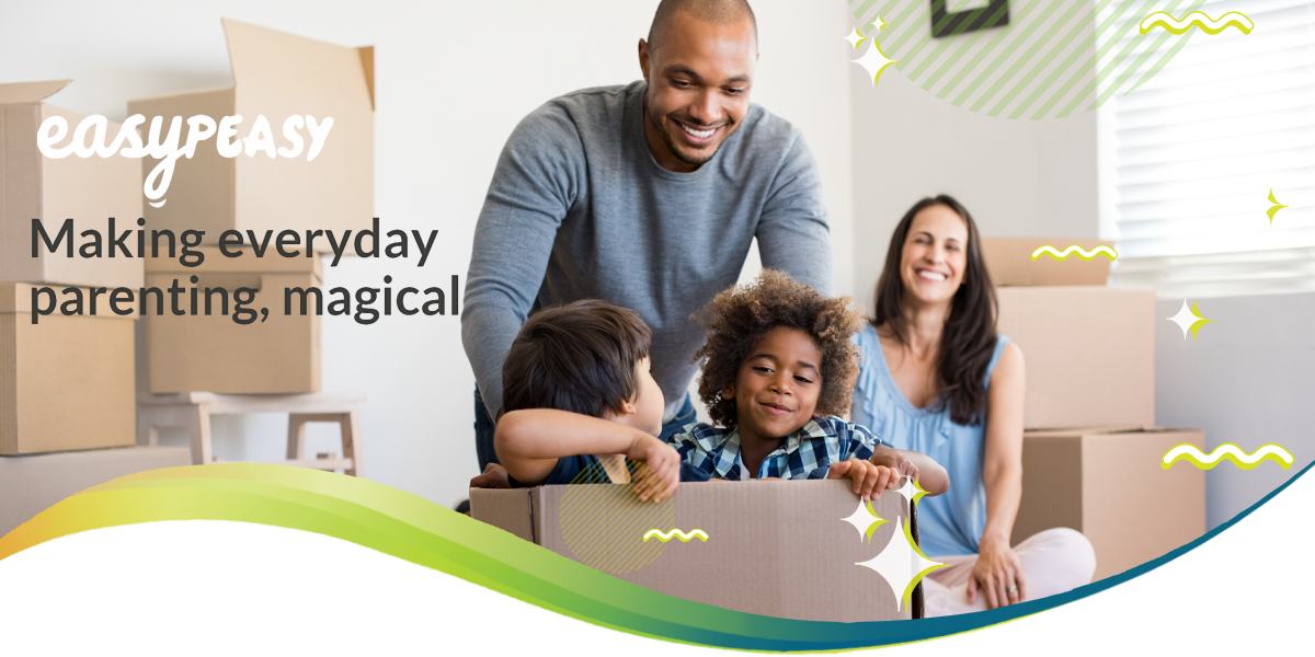 Blog banner showing parents playing with their two children who are sat in a big cardboard box