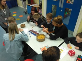 Families at Lister Infants using multi-coloured pipe cleaners to make shapes