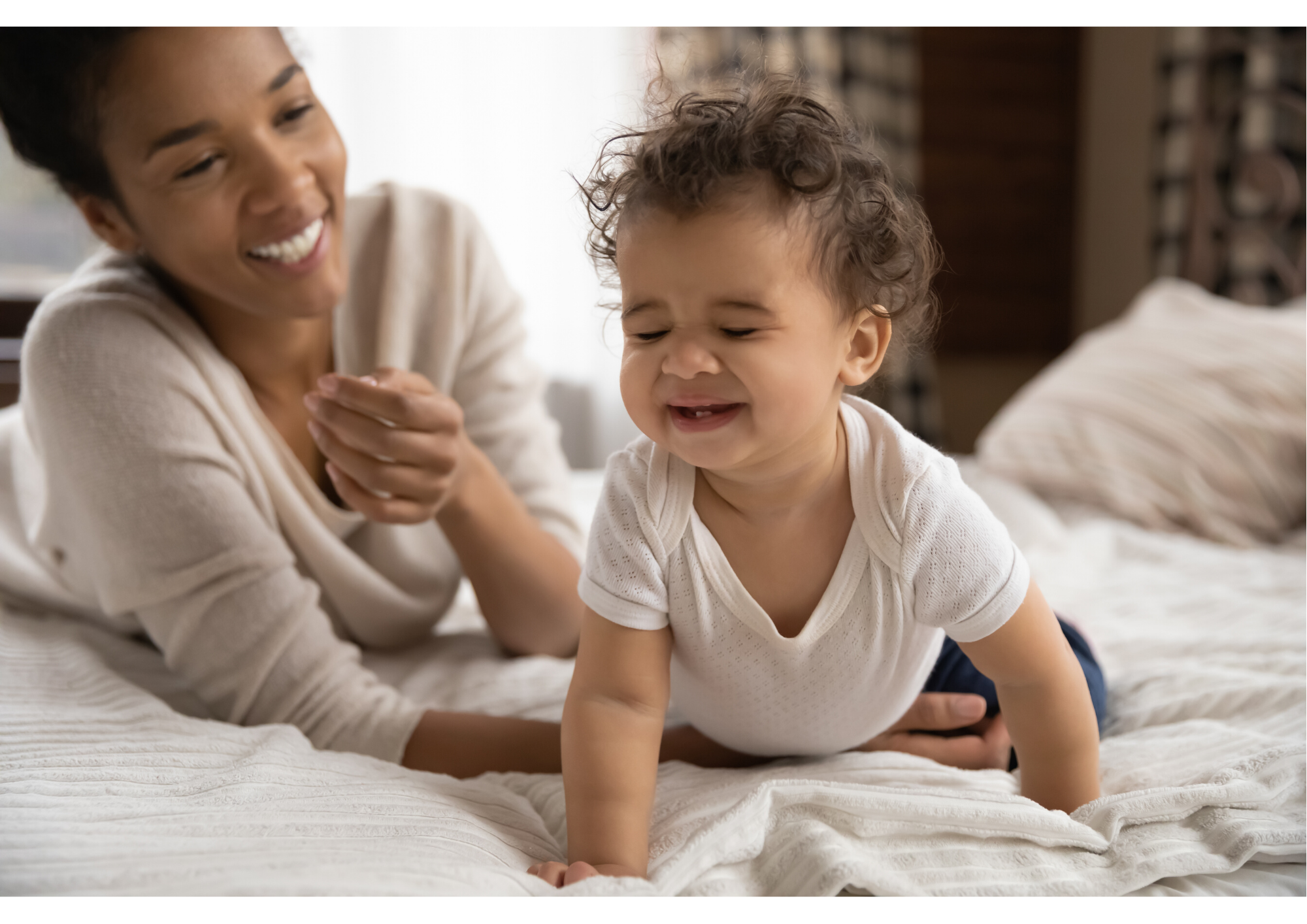 New mum on a bed enjoying one-on-one time with with her child