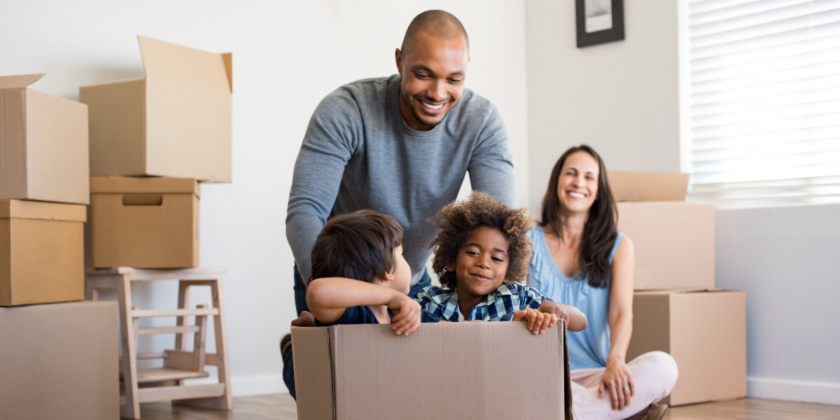 Dad and mum reconnecting with their children while they play in cardboard boxes