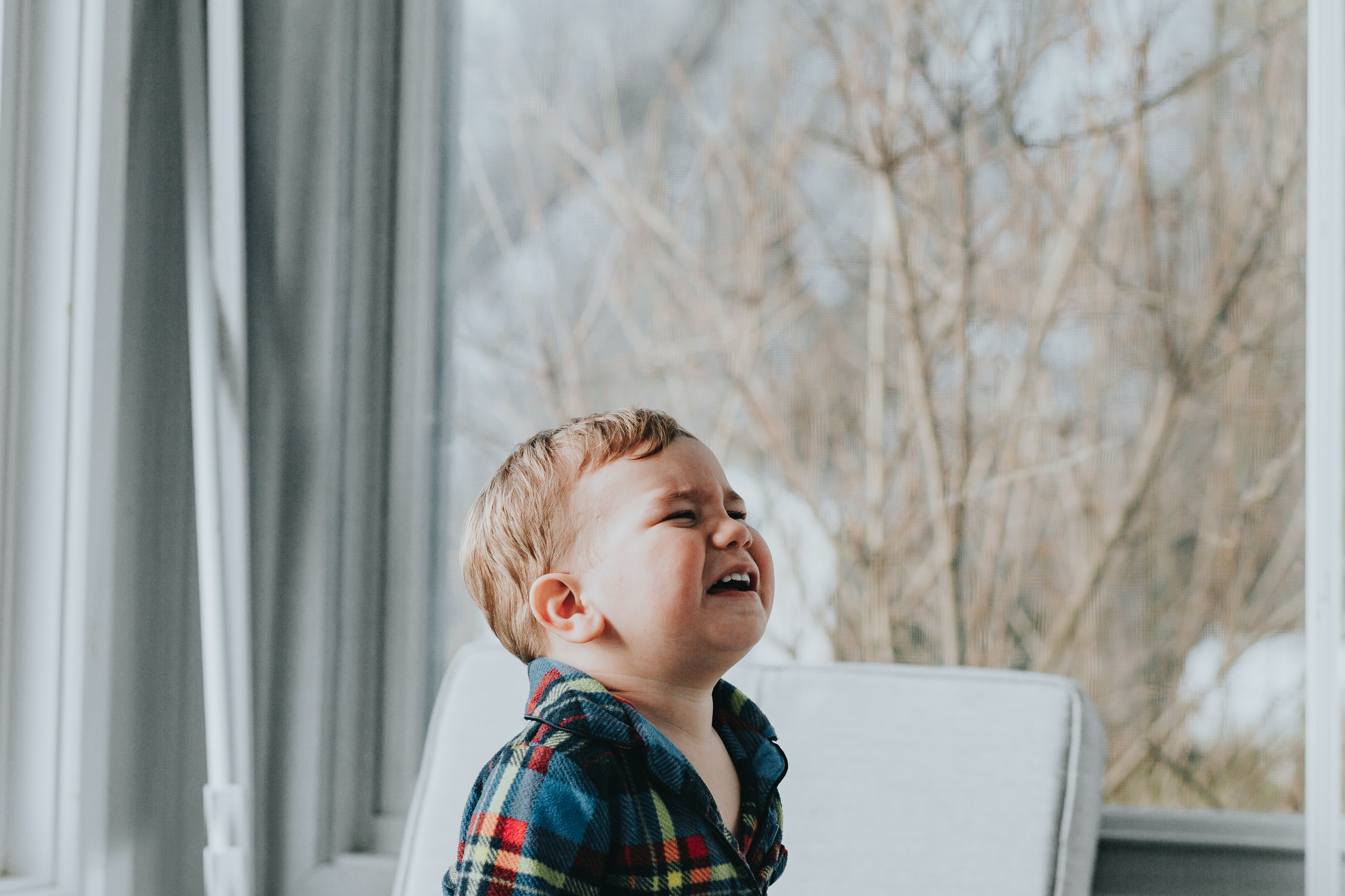 Emotional toddler throwing a tantrum at home