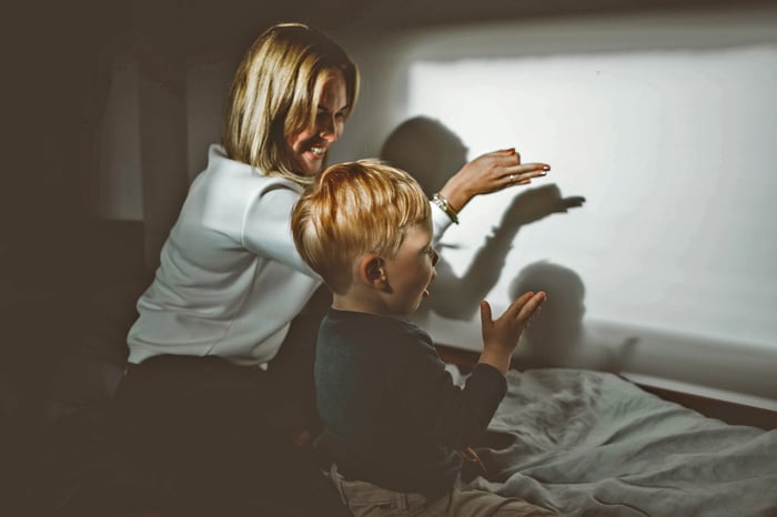 Mother and Son creatig shadow shapes at home during the 2nd lockdown in the UK