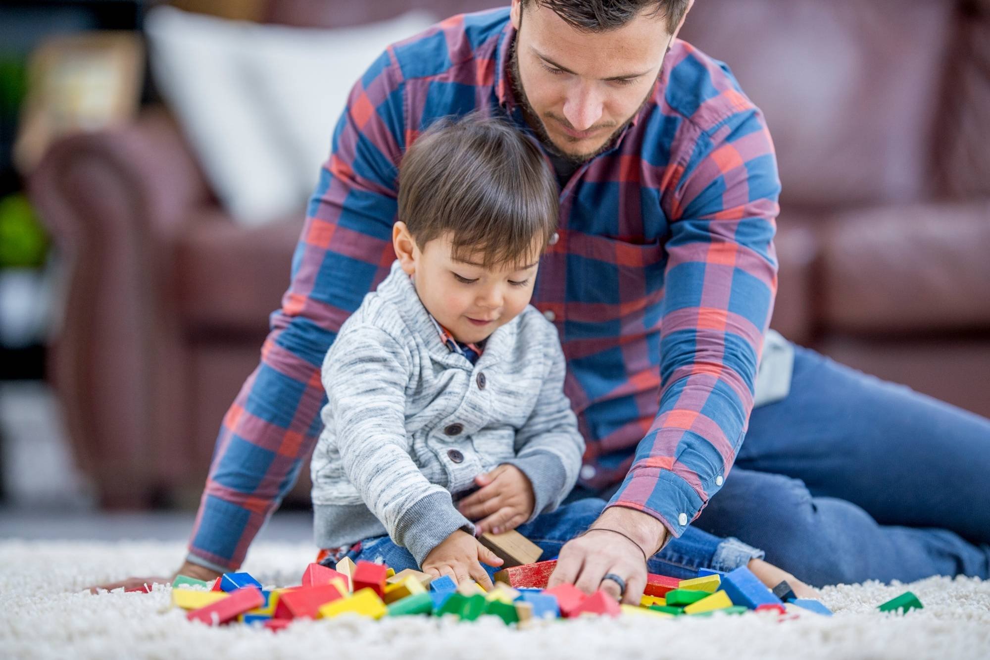 Toddler boy playing with father