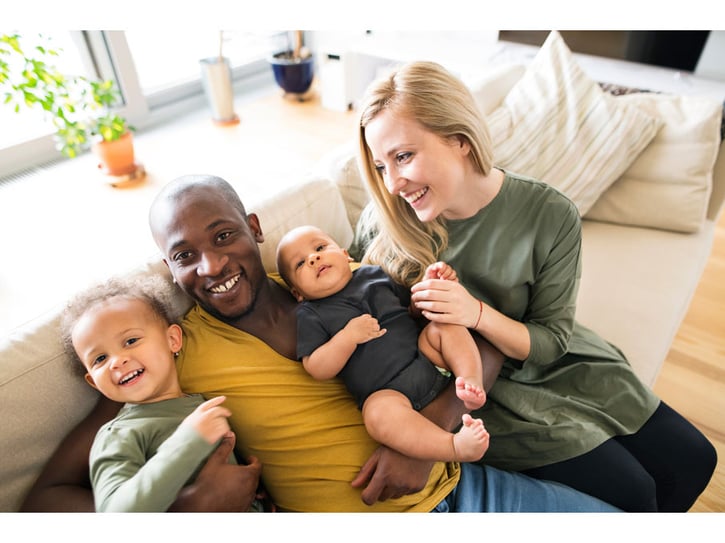 New parents spending time and forming a bond with their toddler and baby