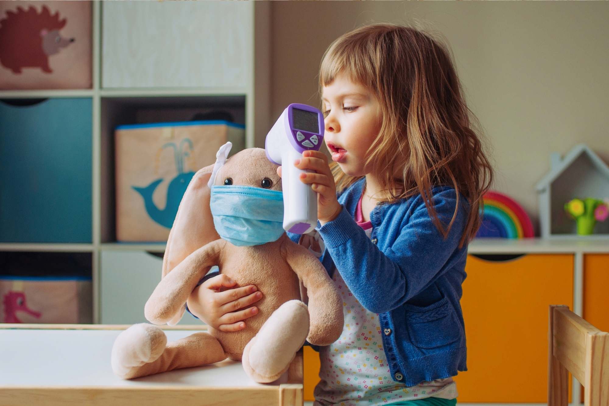 Little girl playing with her rabbit - imaginary play