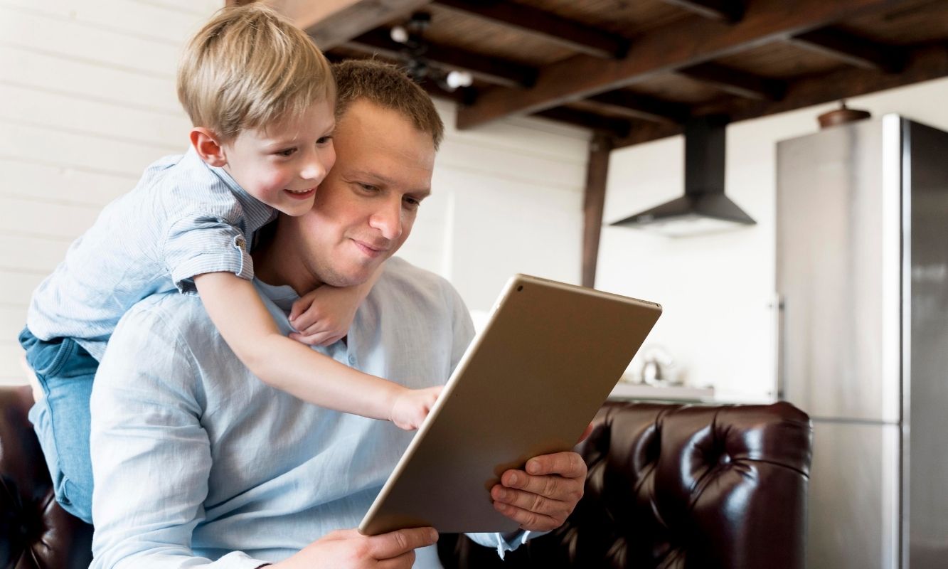 Dad and son looking at picture frame