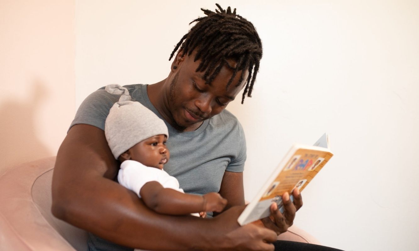 Dad reading to his baby