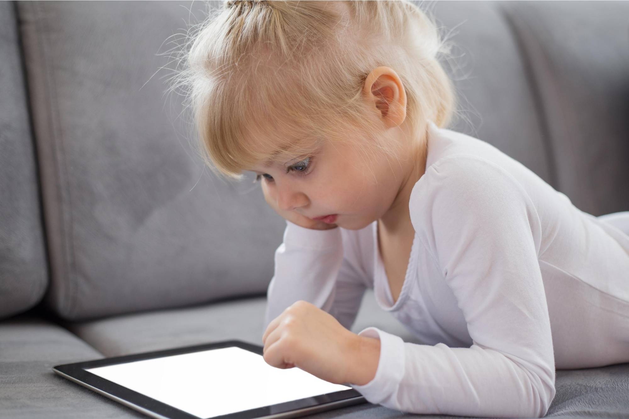 Child using an educational app on an iPad 