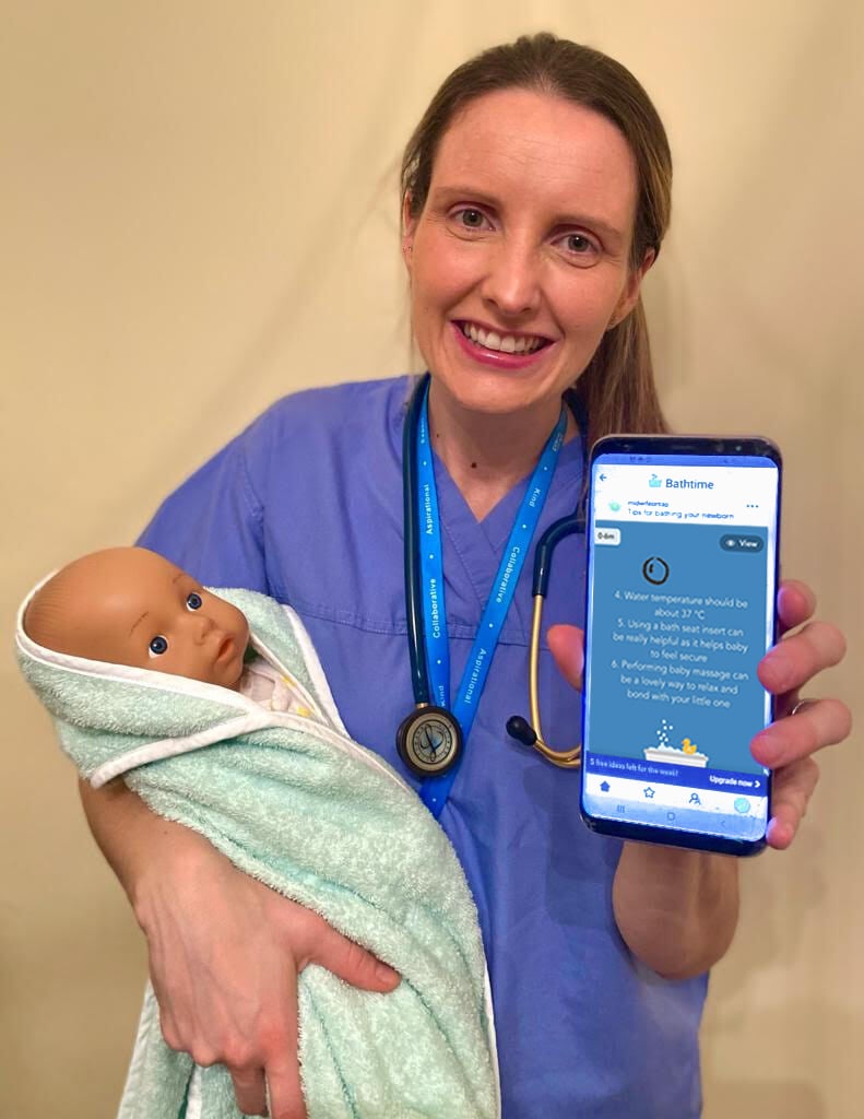 Midwife Anne power holding a baby doll and a phone displaying her EasyPeasy tips 